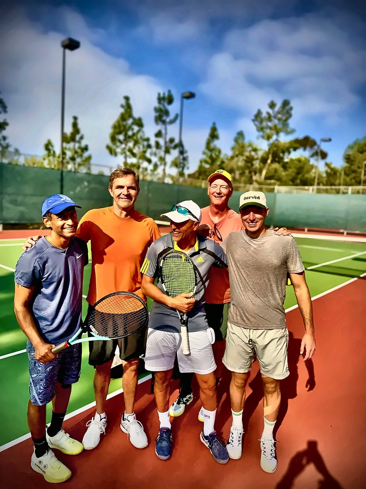 Adult clinic group smiling with Coach Fawz