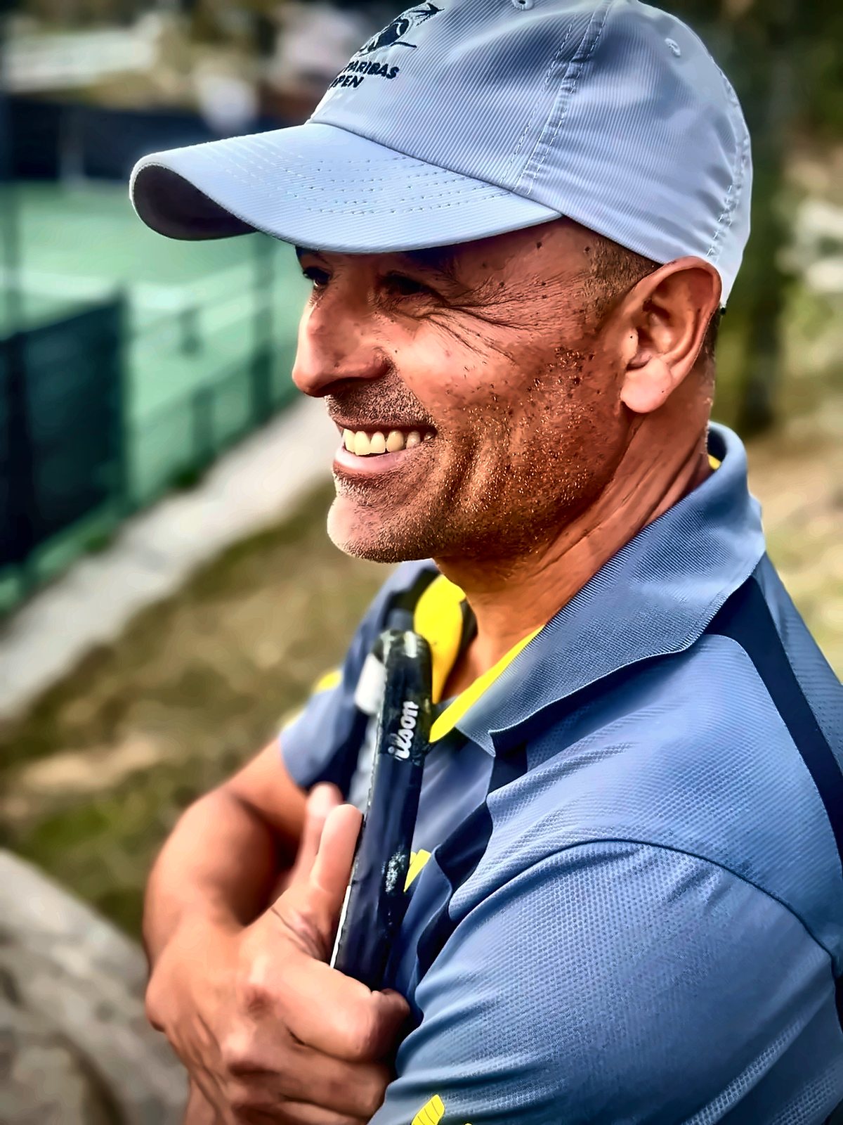Coach Fawz Ksikes courtside with his racket