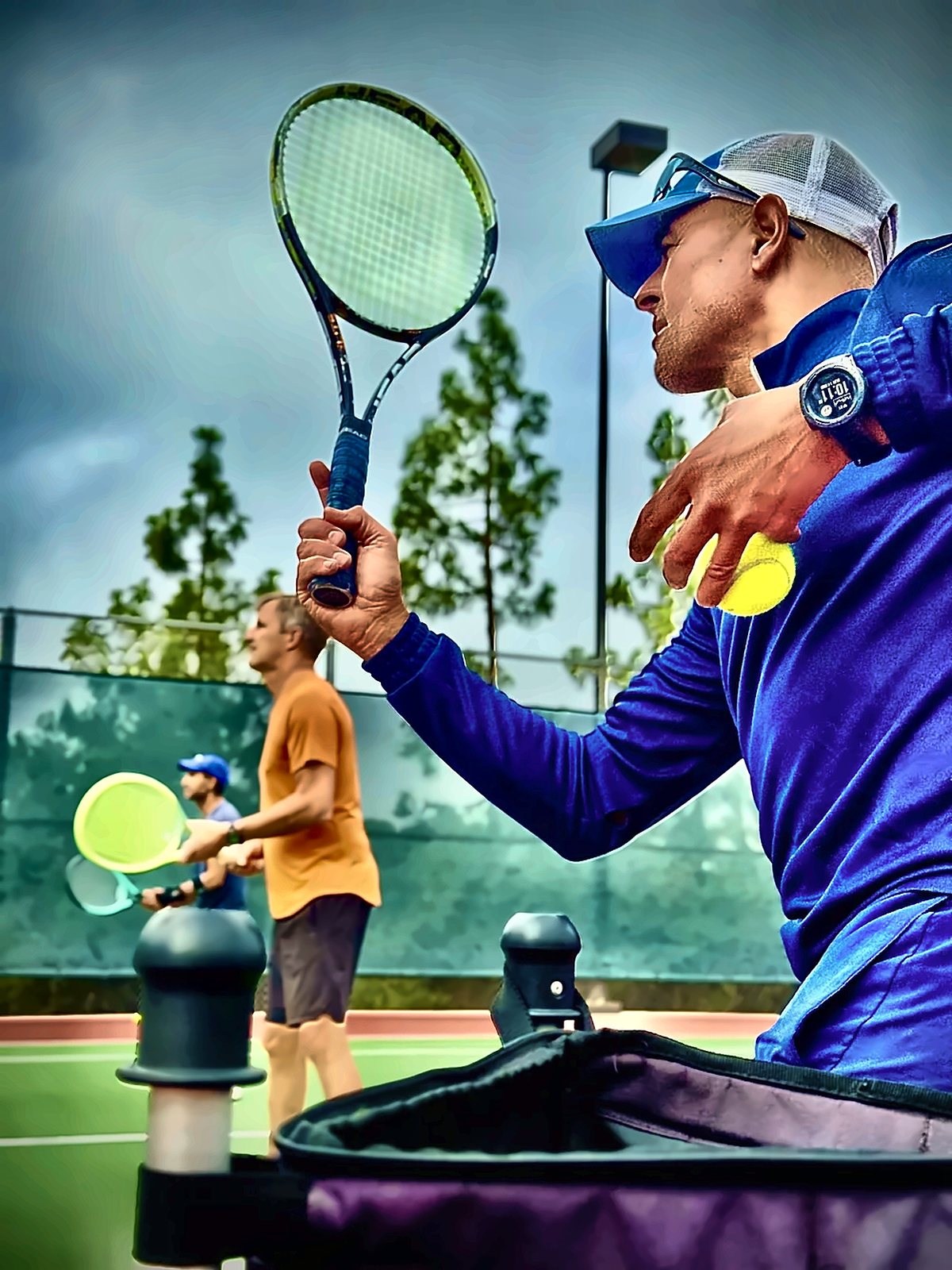 Fawz feeding balls during a drill