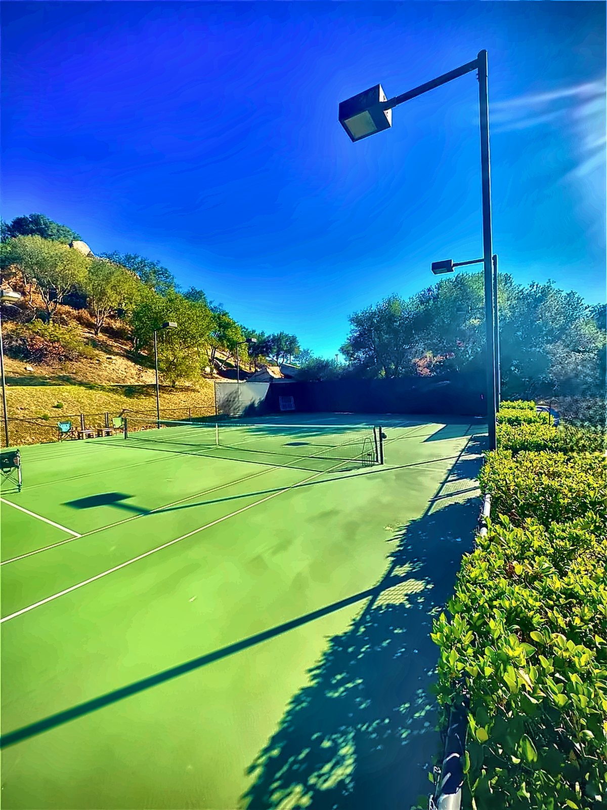 Fawz's private tennis court under a blue sky