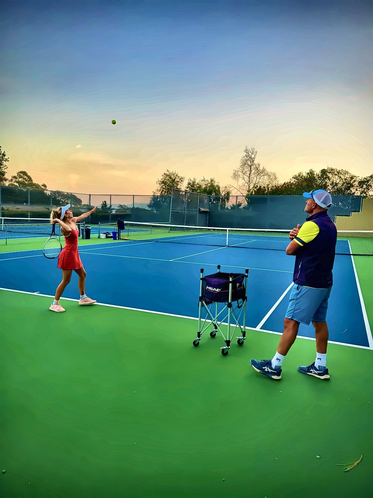 Evening junior lesson on a blue hard court
